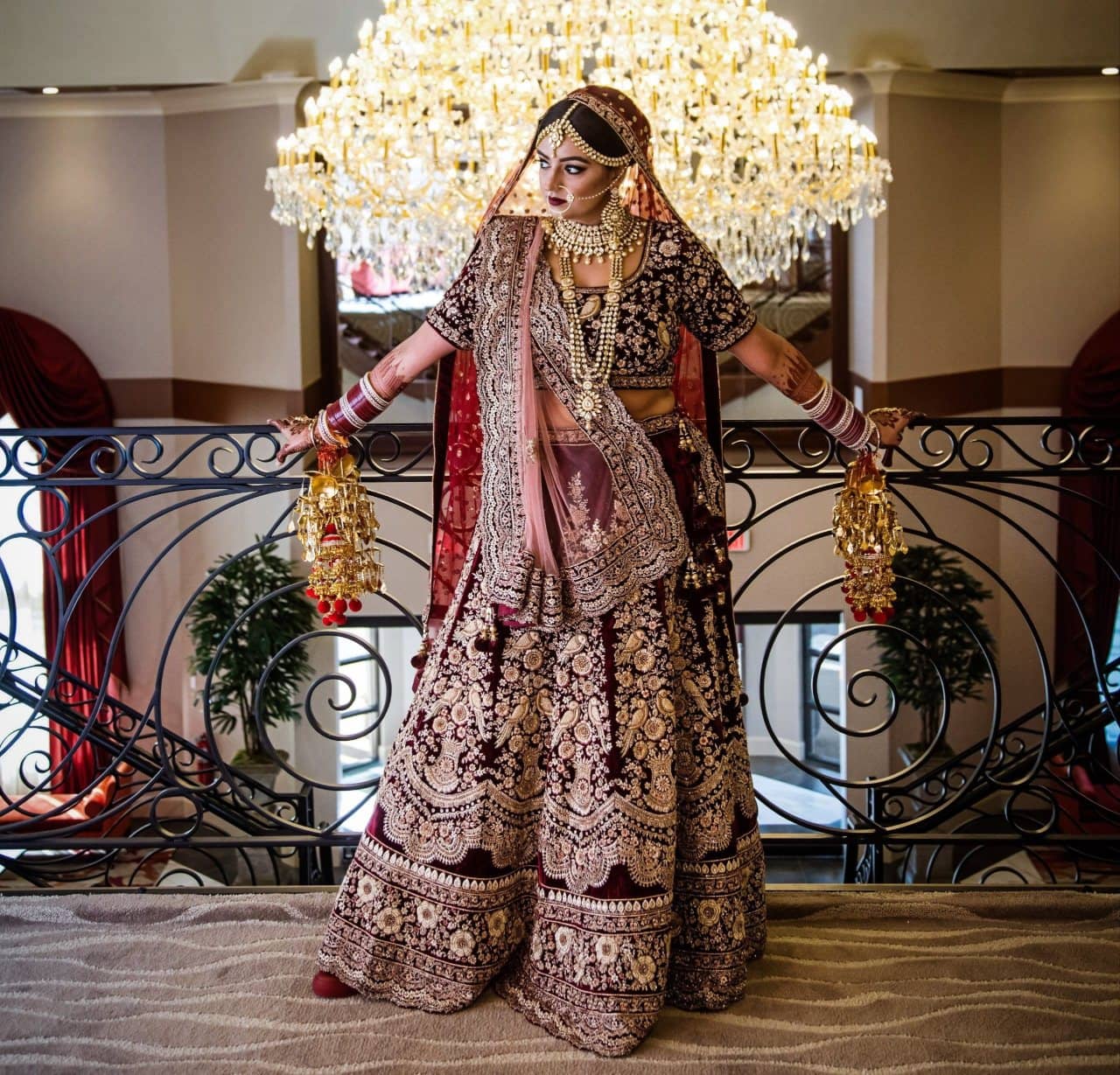 Heavily embroidered wine colored lehenga with extra flares and net <em>dupatta</em>