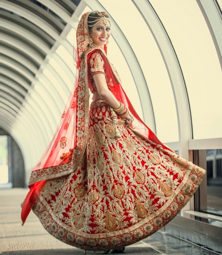 Red bridal lehenga with golden embroidery and thread work