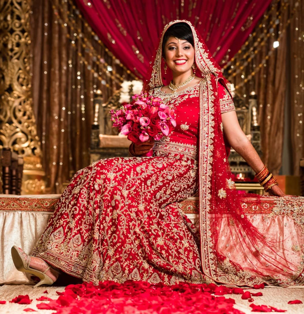 Cherry red Punjabi bridal lehenga with minimal <em>choli</em> designs
