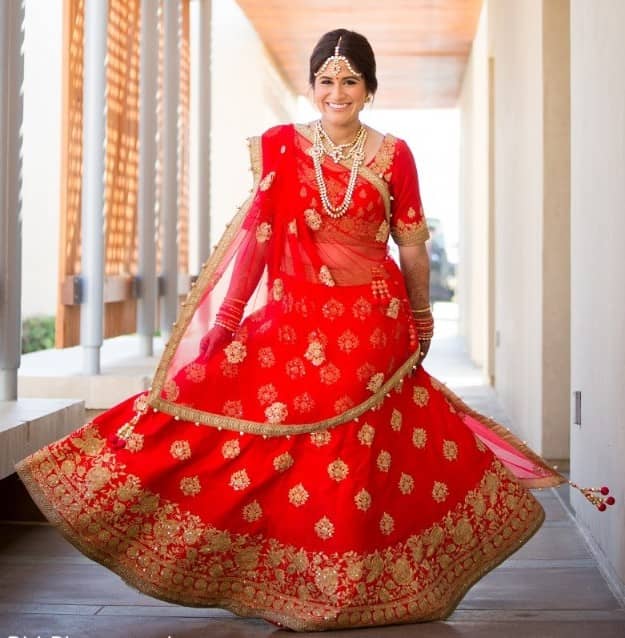 Red Punjabi bridal lehenga with minimal golden thread work
