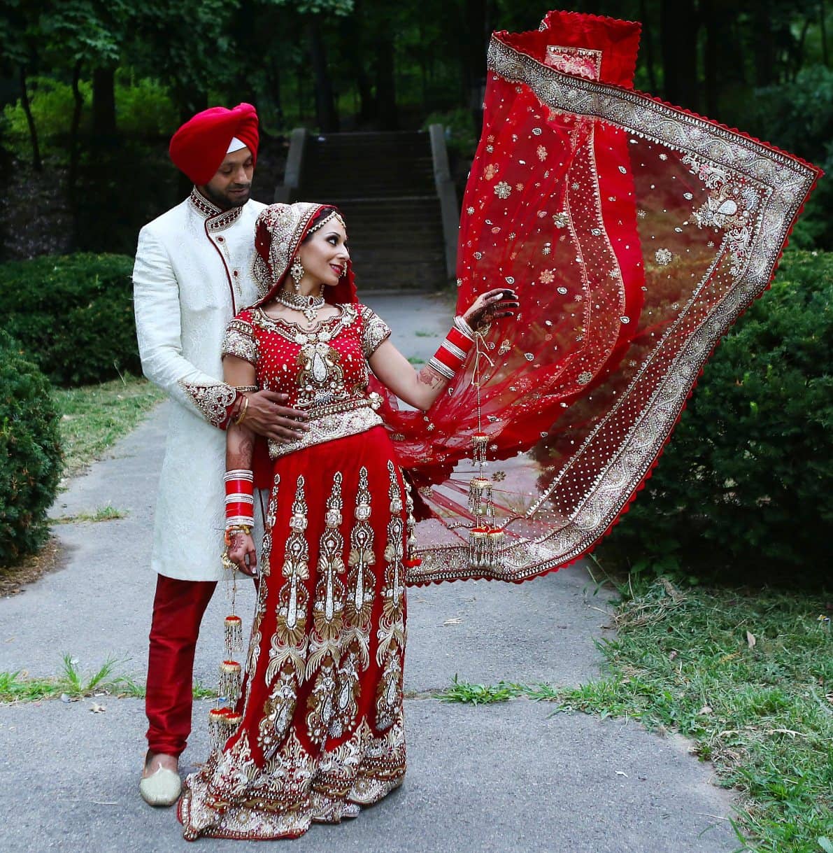 Dark red Punjabi bridal lehenga with long and stylish <em>choli</em>