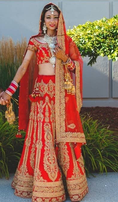 Straight cut bridal lehenga in red with golden zari and embroidery work