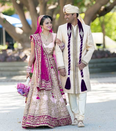 Baby pink and purple Punjabi bridal lehenga with golden zari work