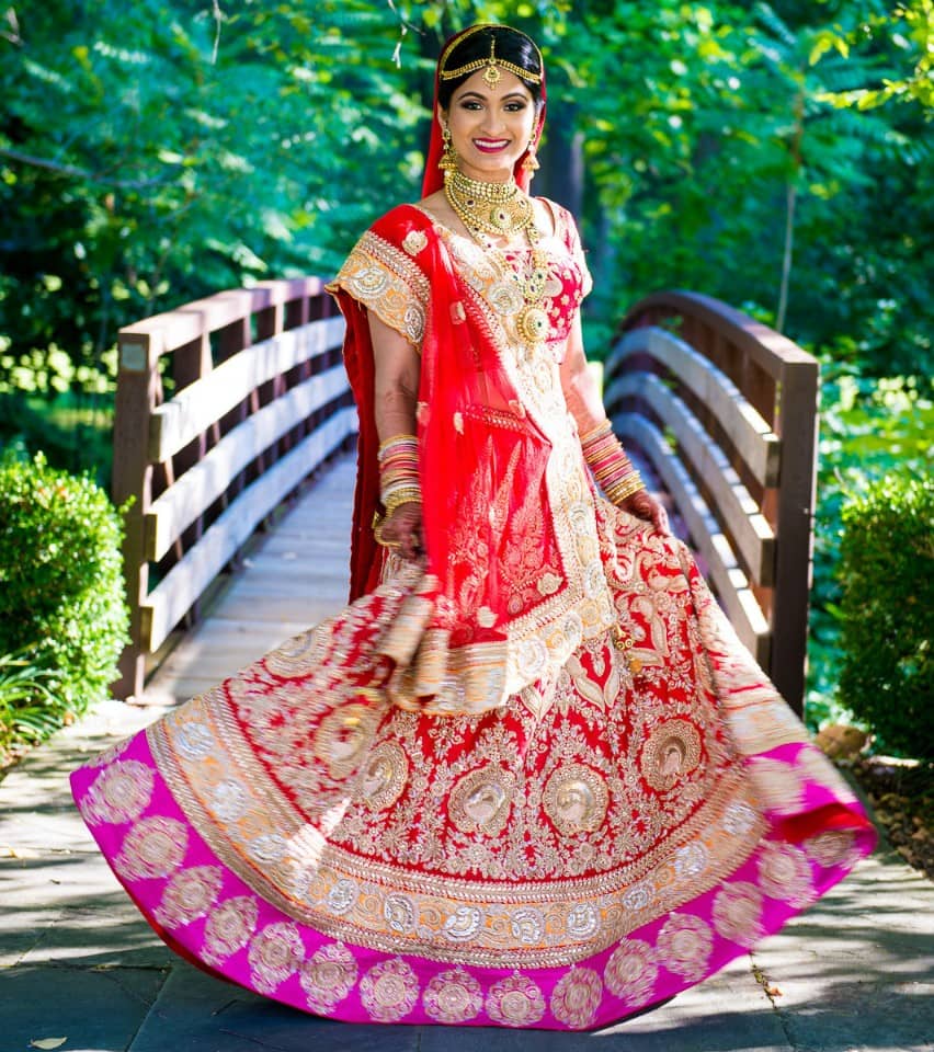 Heavily embellished gorgeous bridal lehenga in shades of orange, purple and red