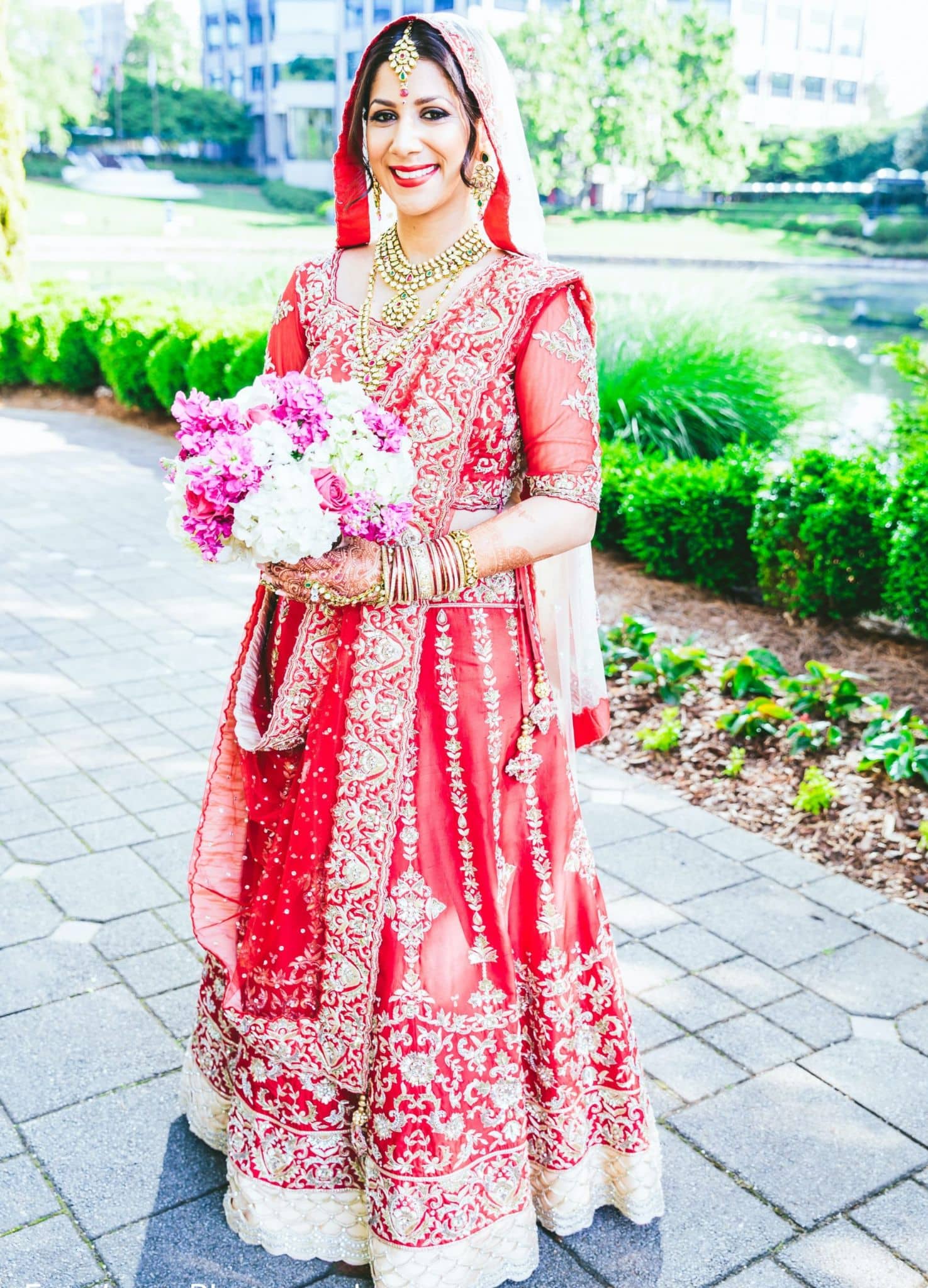 Red Punjabi bridal lehenga with golden embellishments, thread work, and zari work all over