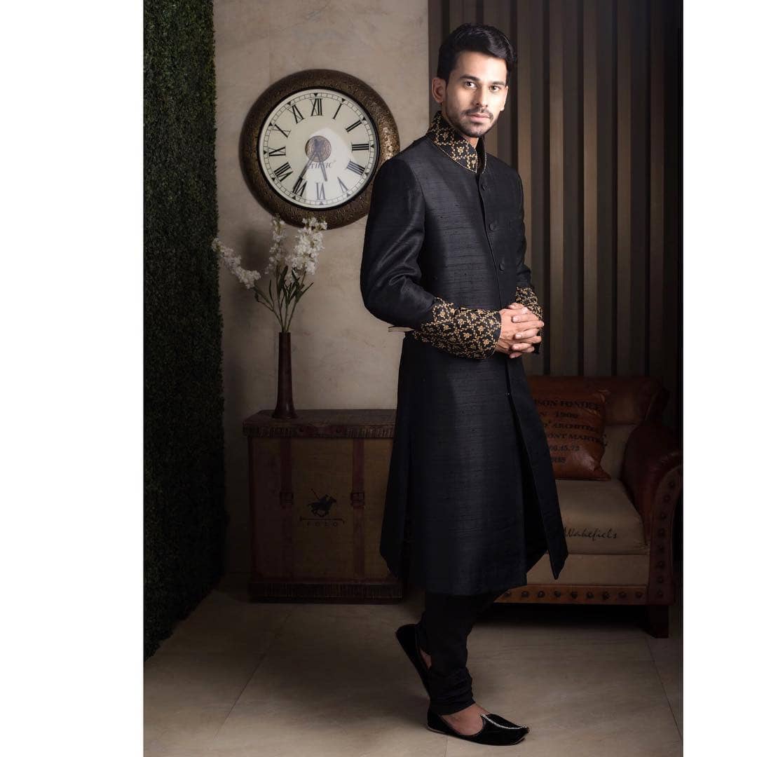 Trendy sherwani in black with golden embroidery