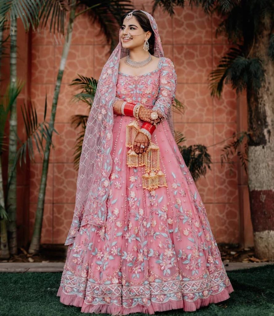 Photo of Bridal portrait with light pink lehenga and blue embroidery with  ombre dupatta