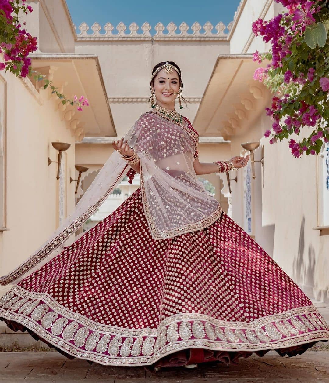 Twirl in style with this maroon bridal lehenga and white net dupatta
