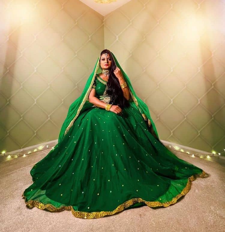 Photo of dark green manish malhotra mehendi look for bride