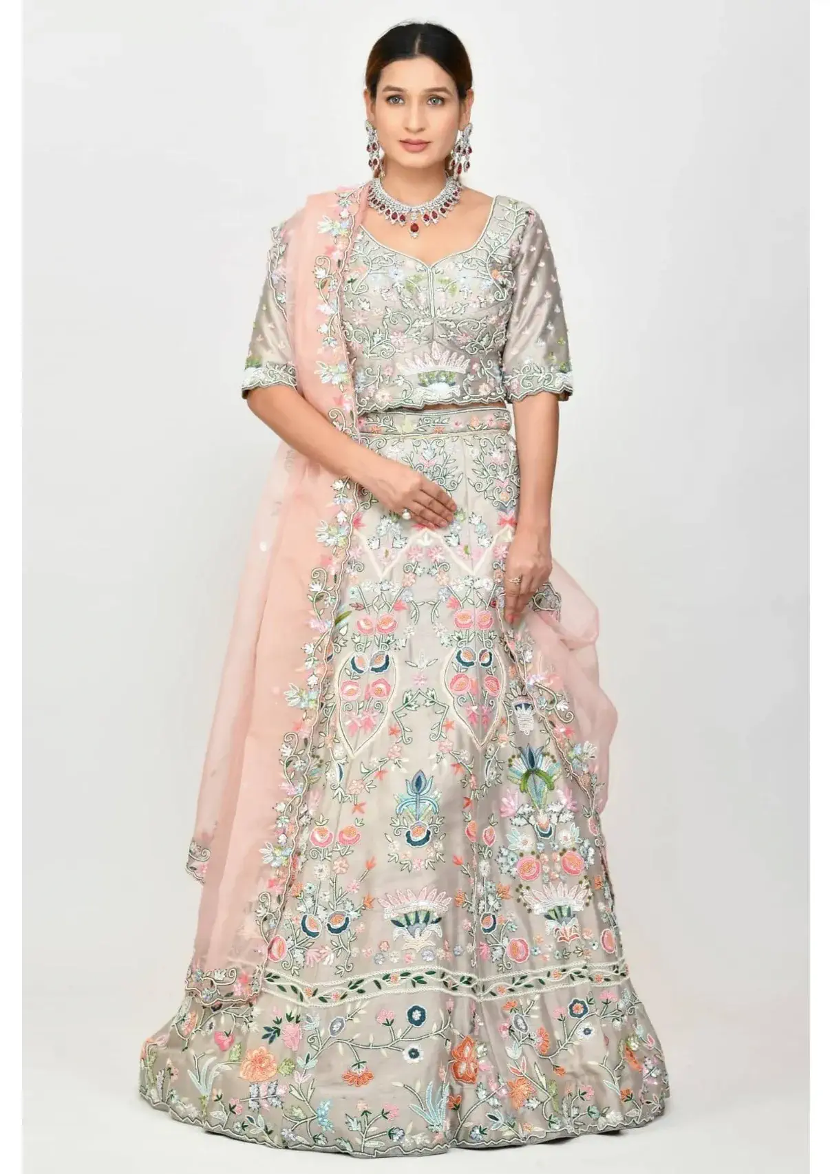 DUSTY PEACH CLASSIC LEHENGA SET WITH ALL OVER PATTERNED EMBROIDERY AND  SHOULDER TASSELED DETAILS PAIRED WITH A MATCHING DUPATTA AND AND ALL OVER  MIRROR WORK AND SILVER EMBELLISHMENTS. - Seasons India